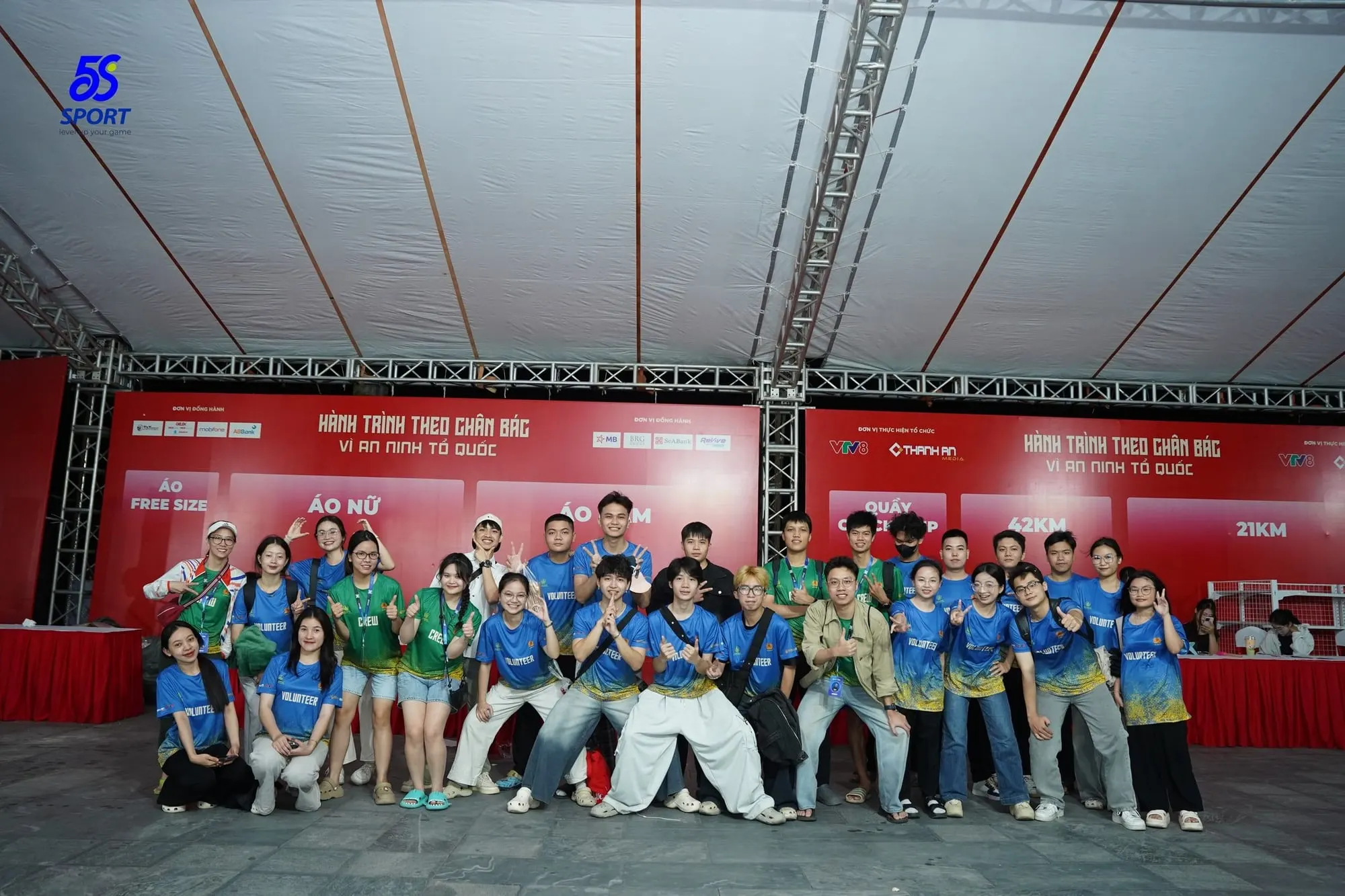 Operations staff and volunteers in a group photo in the race-kit area