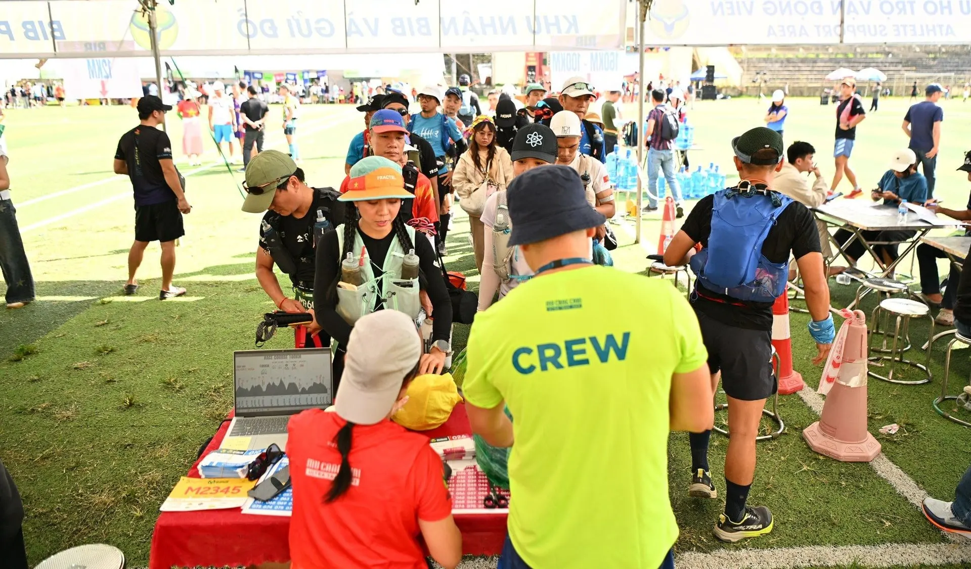 CREW staff checking in a participant at a desk with a laptop