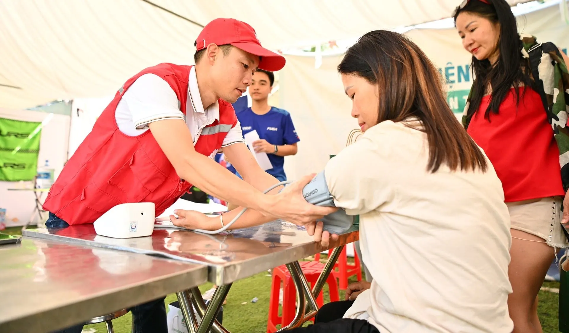 A medic checks a participant's blood pressure